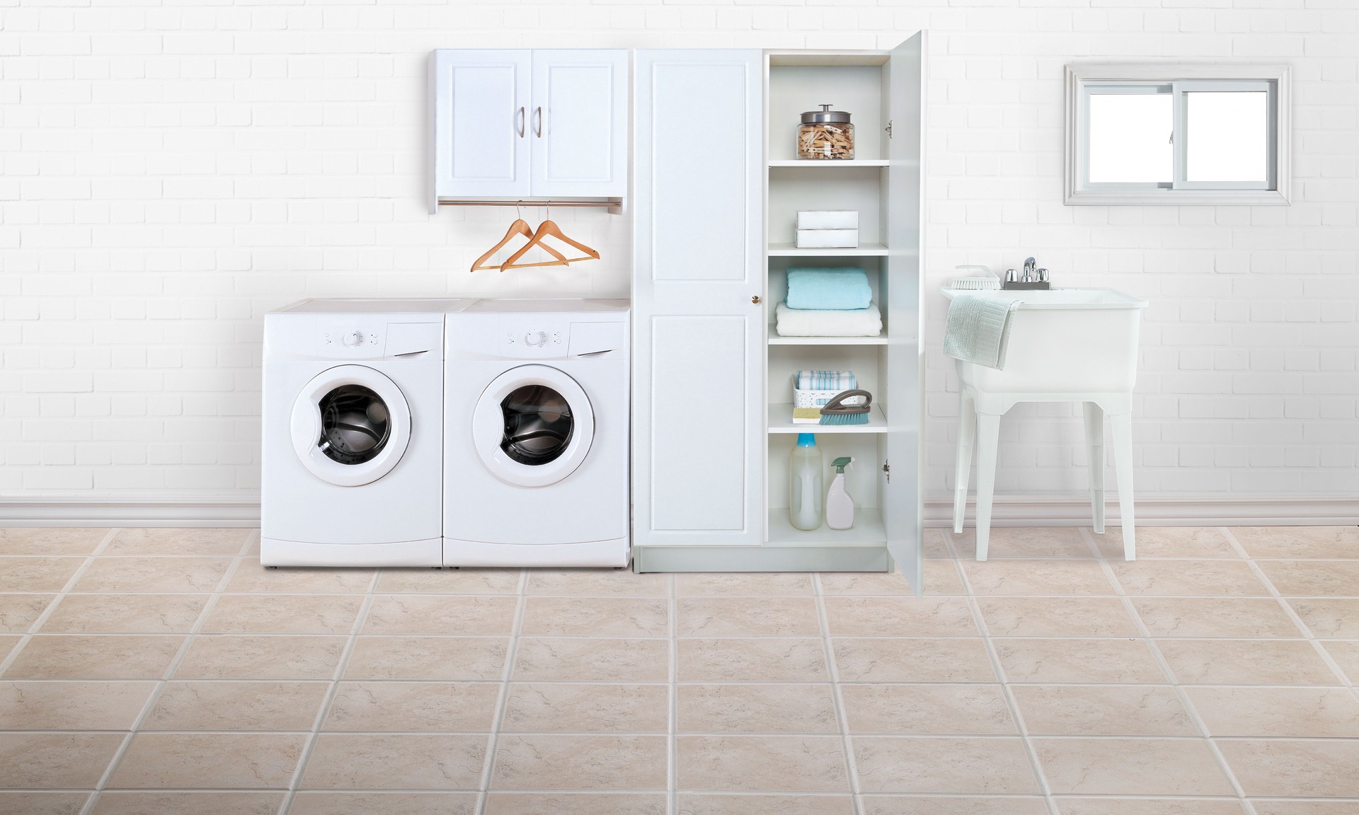 Laundry room with linen cabinet and washing machine on a tiled floor